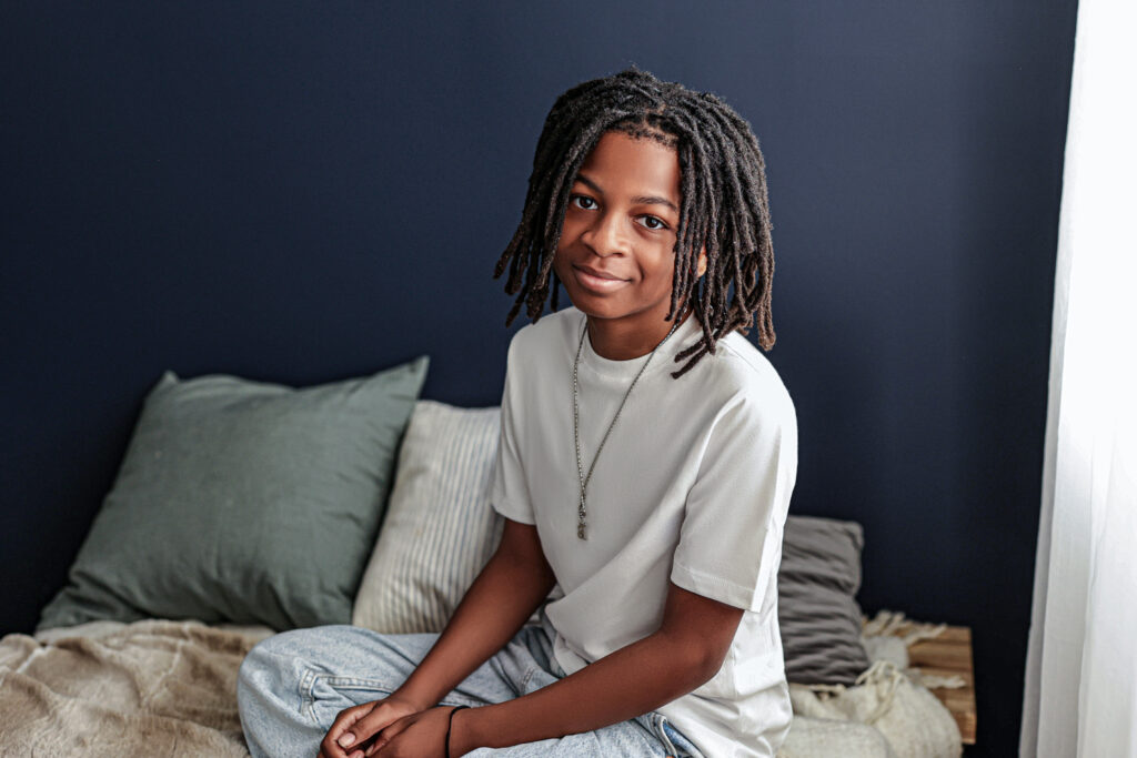 family photos portrait of young black boy on navy blue backdrop